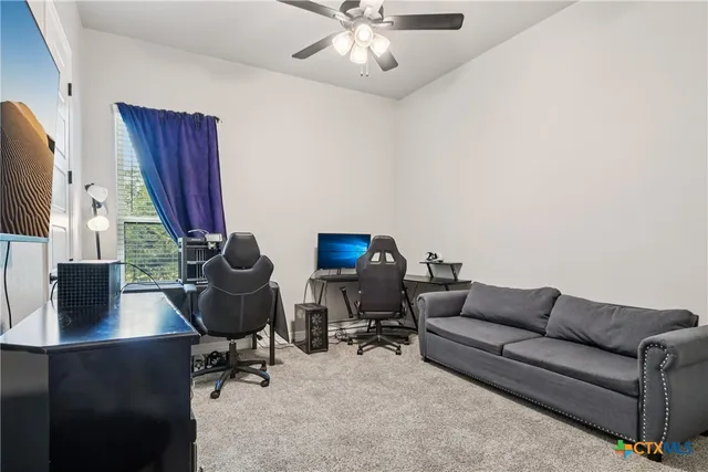 a livingroom with workspace and a couch