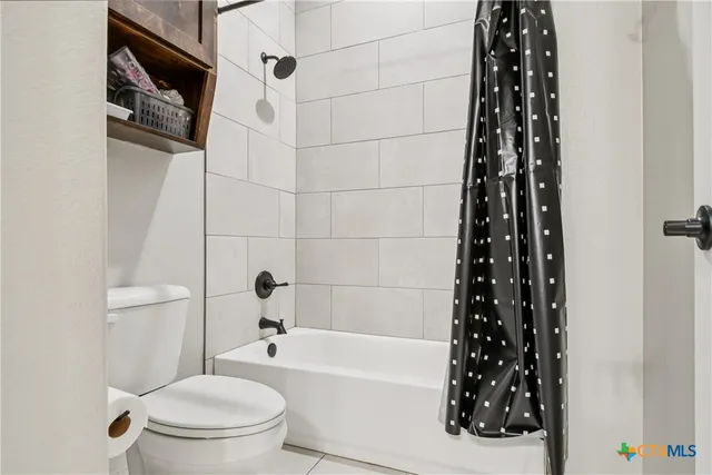 a bathroom with a toilet a sink and bathtub
