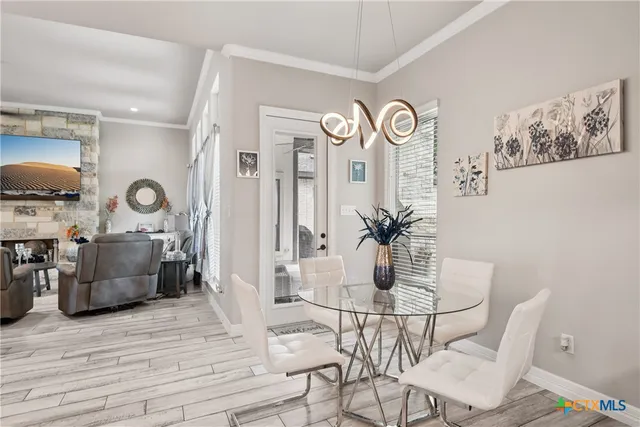 a dining room with furniture and wooden floor