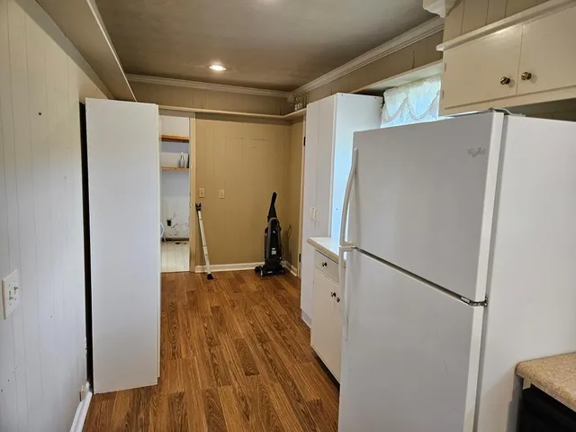 wooden floor in an empty room with a fireplace