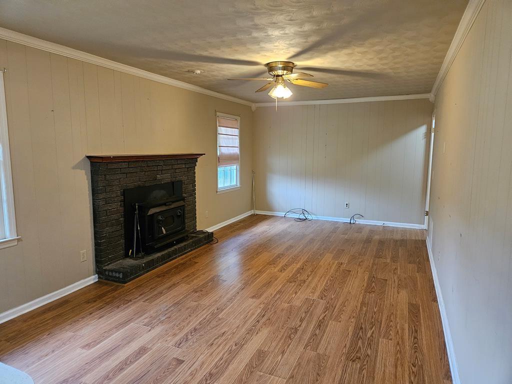306 Grady Whitton Road Bremen, GA 30110 - Photo 30 of 48 wooden floor in an empty room with a fireplace