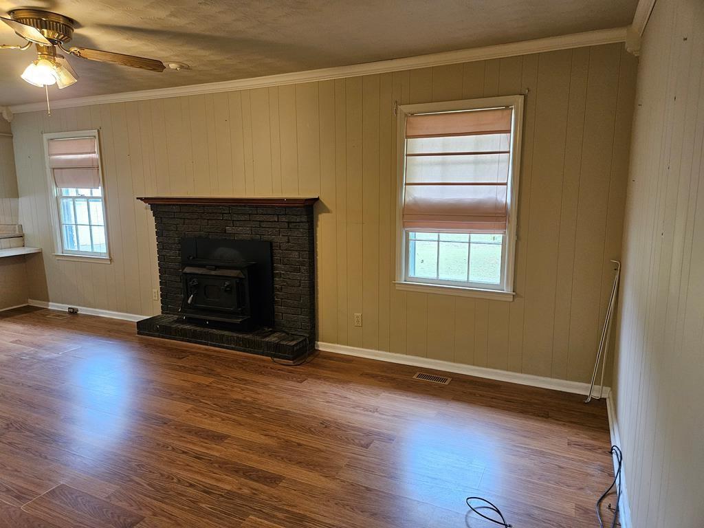 306 Grady Whitton Road Bremen, GA 30110 - Photo 32 of 48 an empty room with wooden floor fireplace and windows