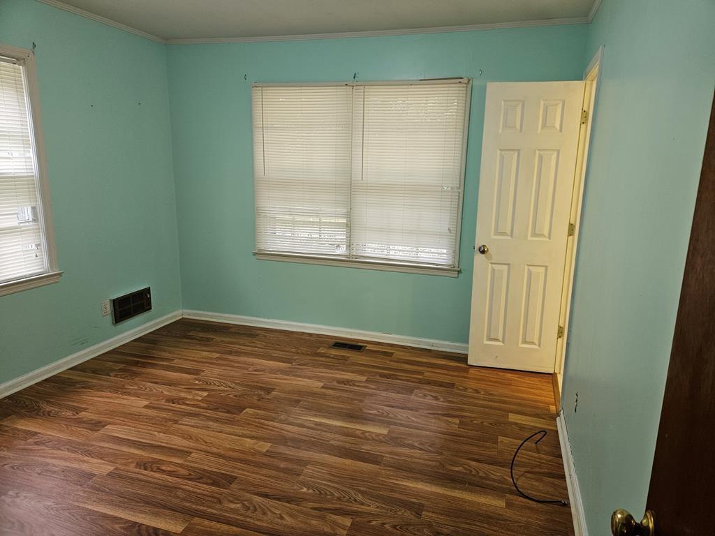 306 Grady Whitton Road Bremen, GA 30110 - Photo 39 of 48 an empty room with wooden floor and windows