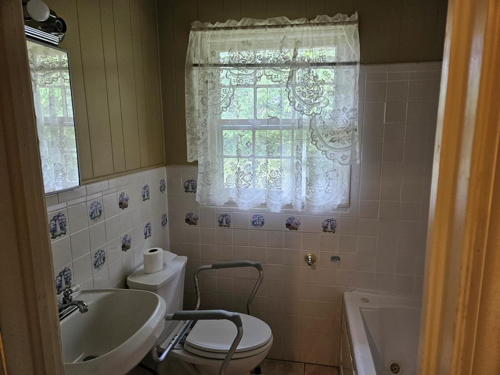 306 Grady Whitton Road Bremen, GA 30110 - Photo 46 of 48 a white toilet sitting next to a bathroom sink