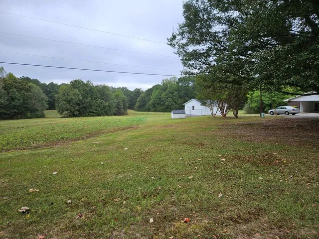 a view of outdoor space with trees all around