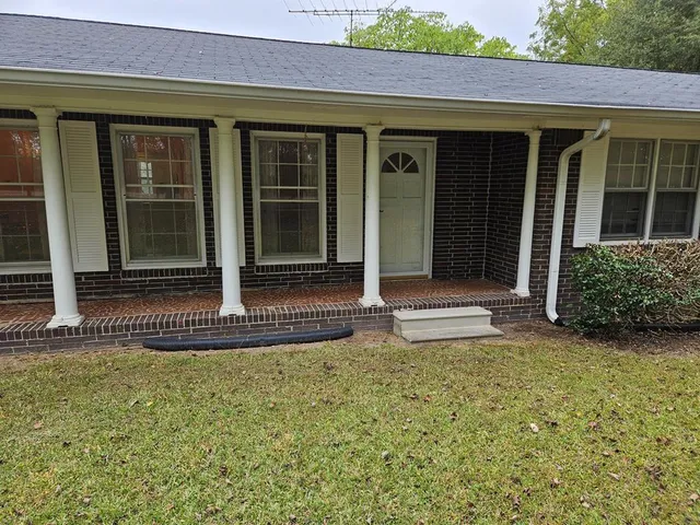 a front view of a house with a garden