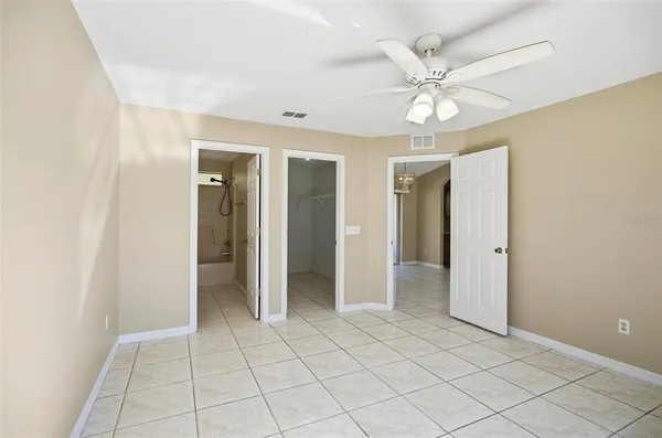 a view of an entryway with a chandelier fan