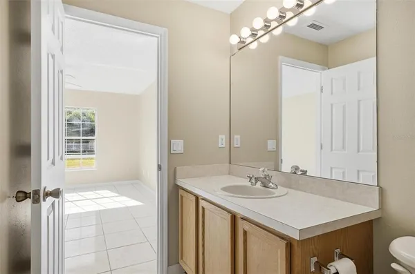 a bathroom with a sink a vanity and a mirror