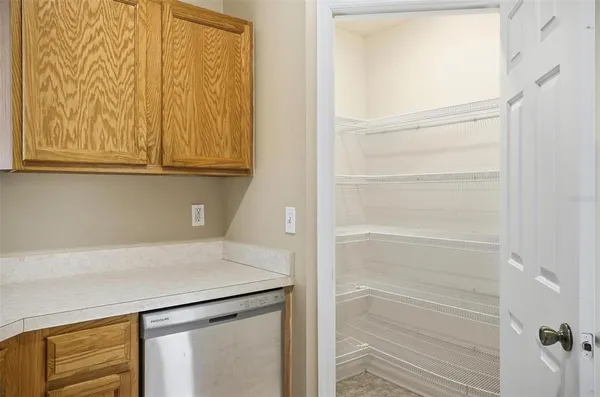 a view of walk in closet with empty racks