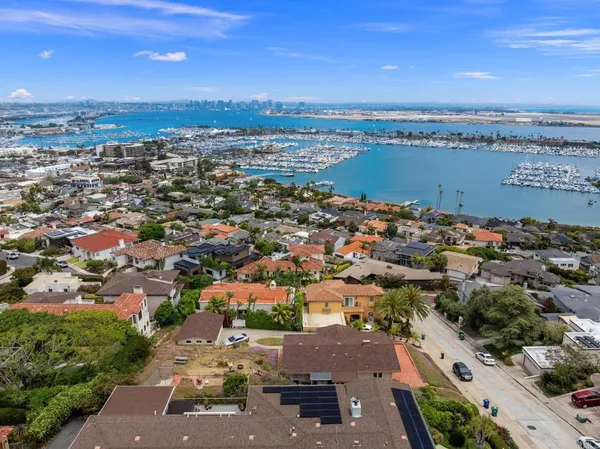 an aerial view of residential houses with a city view
