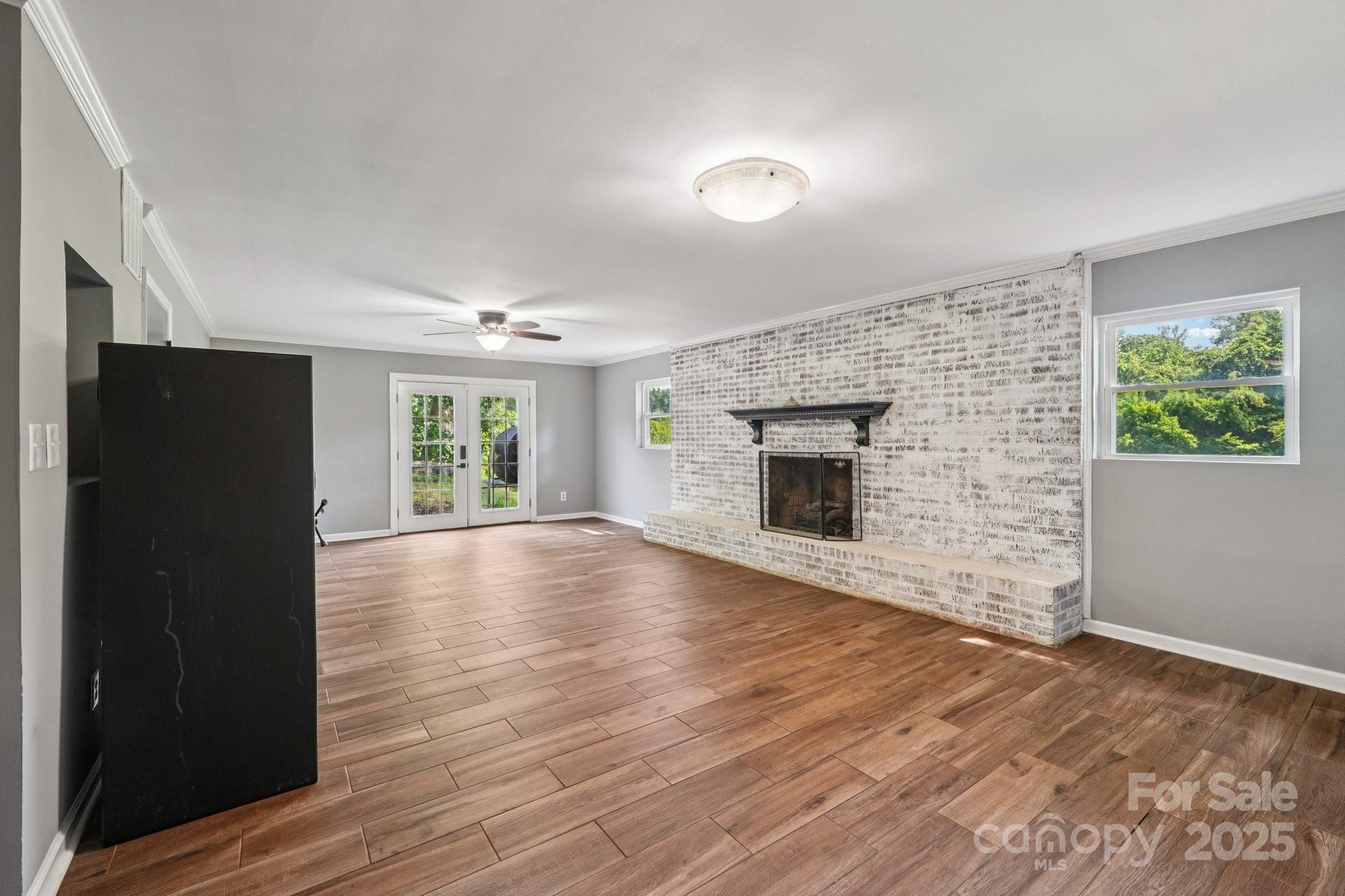 327 Johnson Dairy Road Mooresville, NC 28115 - Photo 23 of 36 an empty room with windows and fireplace
