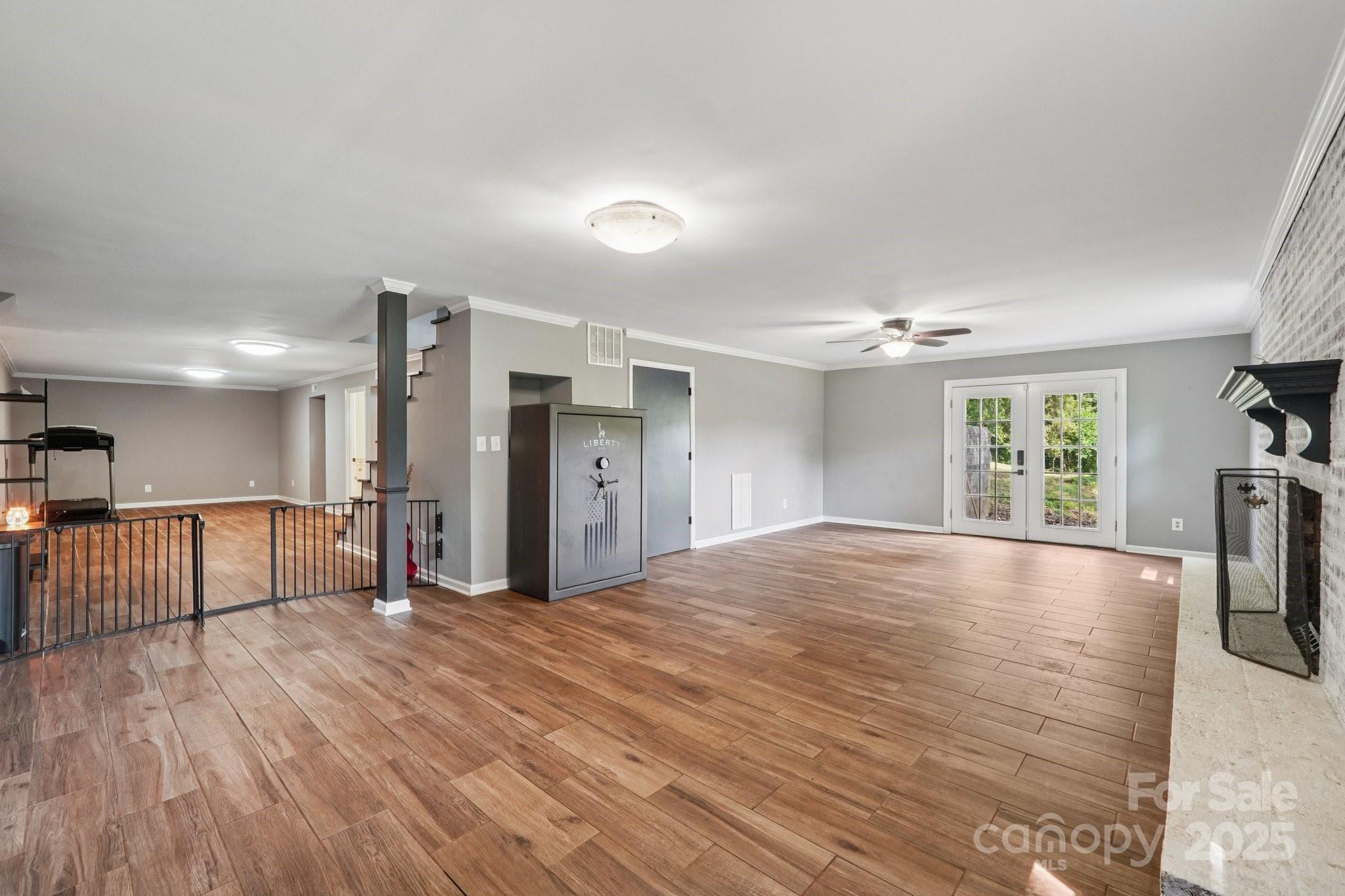 327 Johnson Dairy Road Mooresville, NC 28115 - Photo 24 of 36 a view of an empty room with window and wooden floor
