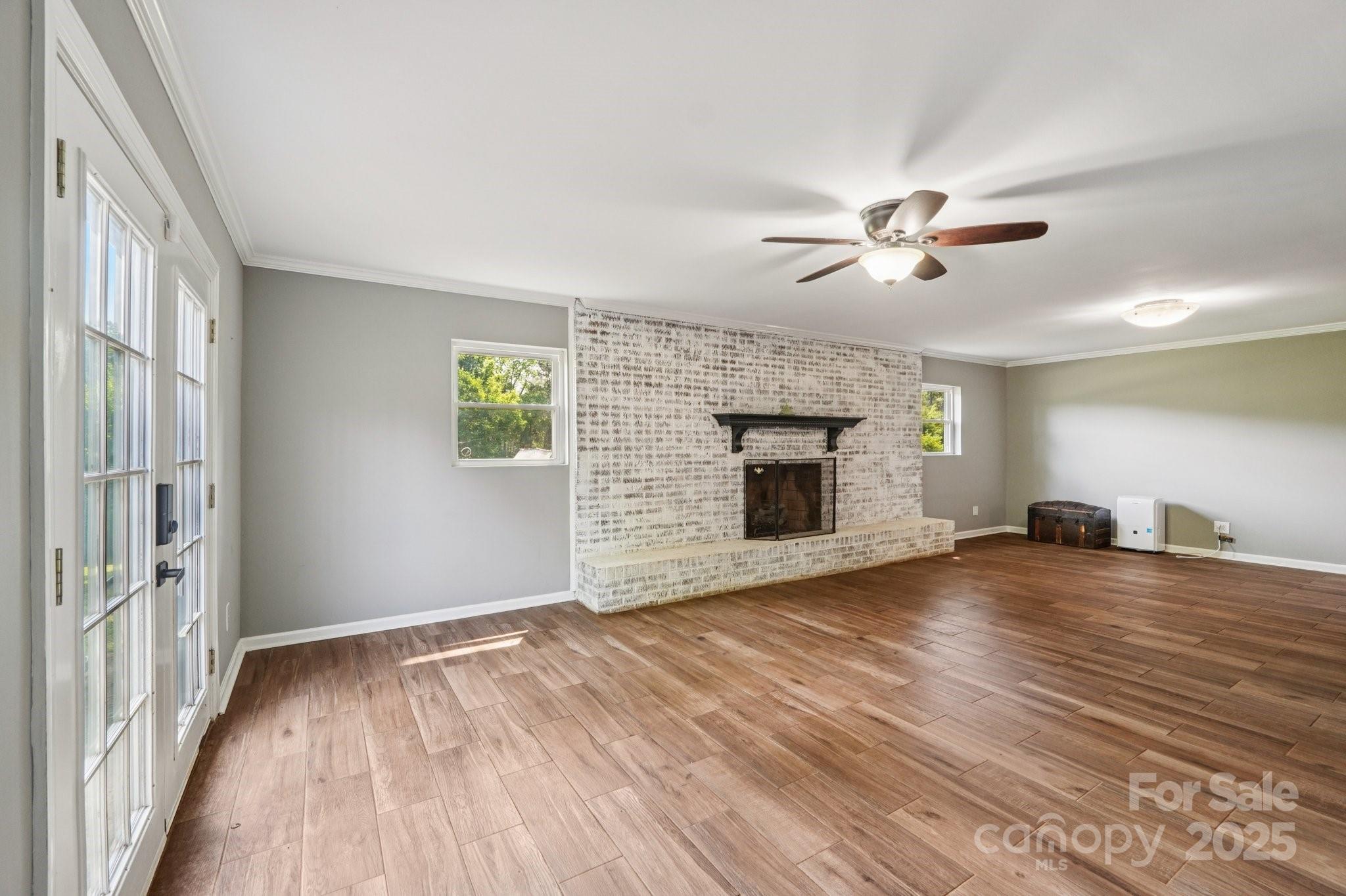 327 Johnson Dairy Road Mooresville, NC 28115 - Photo 25 of 36 a view of an empty room with a fireplace and a window