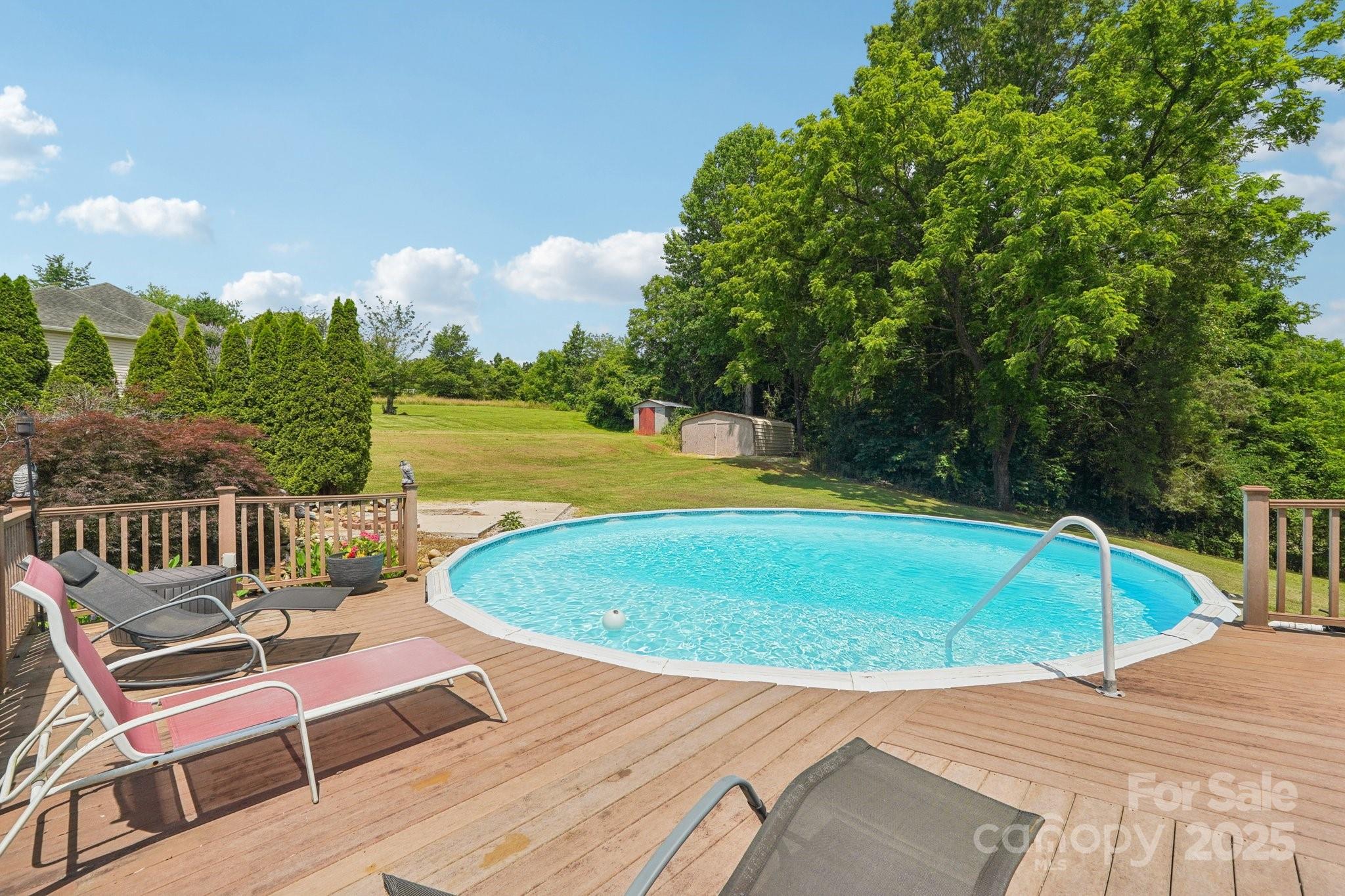 327 Johnson Dairy Road Mooresville, NC 28115 - Photo 30 of 36 a view of a swimming pool with a lounge chairs