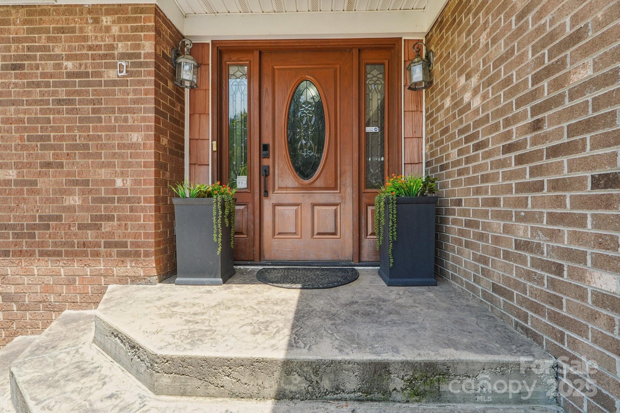 327 Johnson Dairy Road Mooresville, NC 28115 - Photo 3 of 36 a view of a door of a house with potted plants