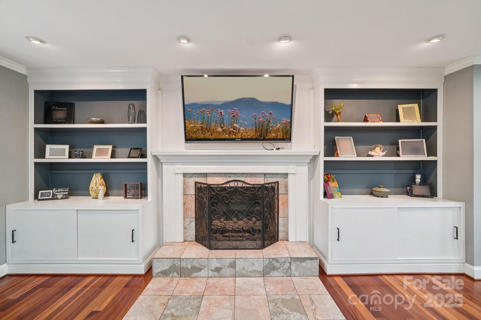 327 Johnson Dairy Road Mooresville, NC 28115 - Photo 7 of 36 a living room with a book shelf and a fireplace