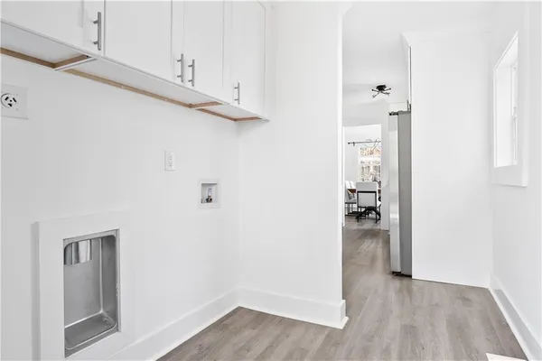 a view of empty room with wooden floor