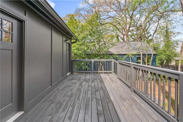 a view of a wooden deck with trees