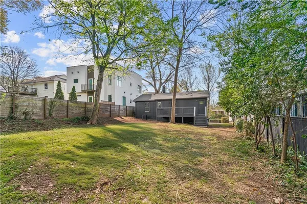 a tall tree in middle of a yard