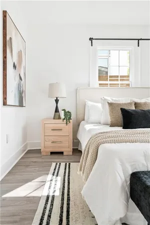 a bedroom with a bed and a large window