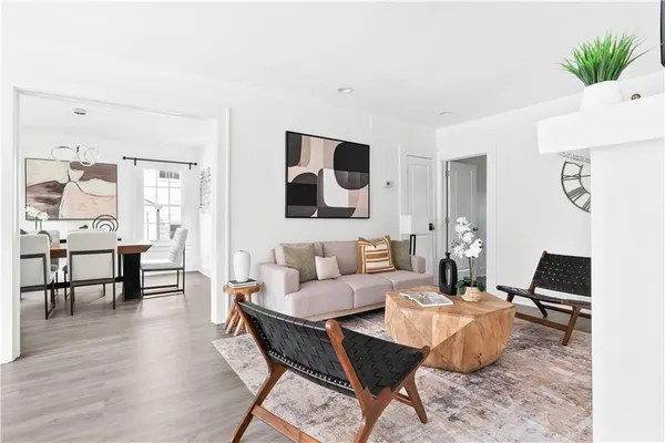 a living room with furniture and wooden floor