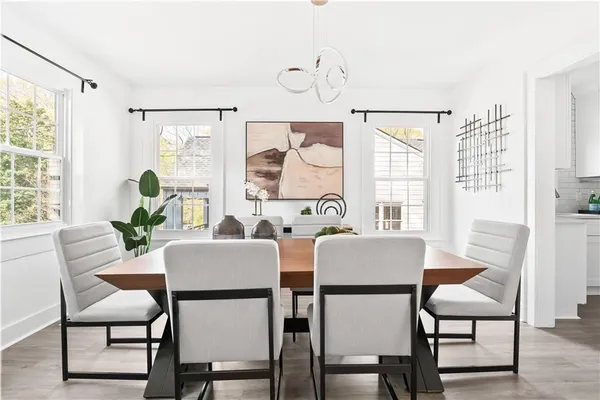 a dining room with furniture and wooden floor