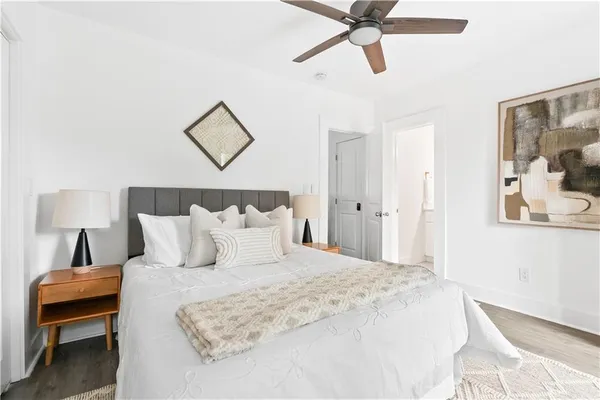 a bedroom with a bed and a painting on the wall