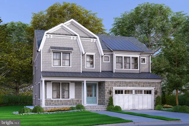 a view of a brick house with a yard plants and large trees