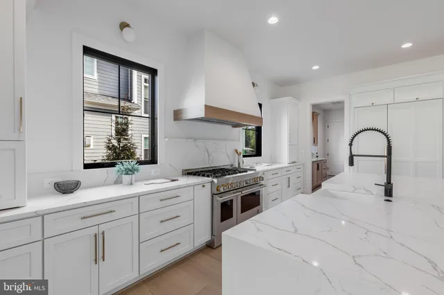 a kitchen with white cabinets and sink