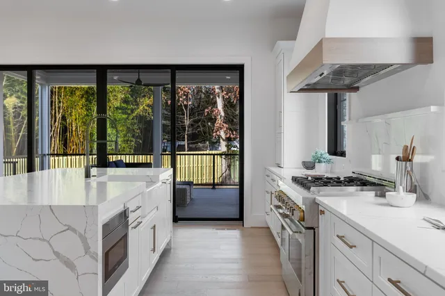 a bathroom with a double vanity sink a tub and a large window