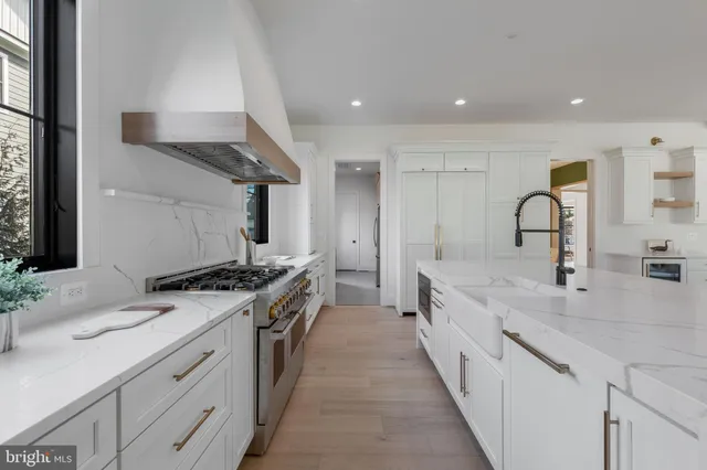 a kitchen with stainless steel appliances granite countertop a sink stove and cabinets