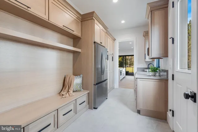 a kitchen with refrigerator and cabinets