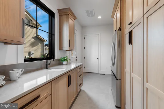 a kitchen with stainless steel appliances a sink and a refrigerator