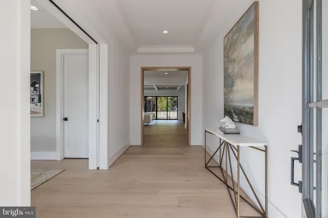 a view of a hallway with wooden floor and windows