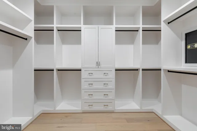a spacious bathroom with a tub a sink and mirror