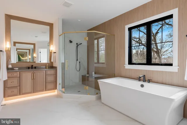 a white bath tub sitting next to a shower