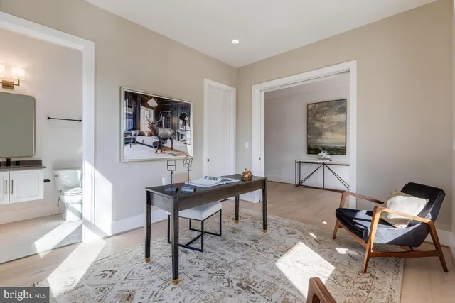 a work room with furniture a flat screen tv and a window