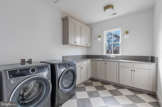 a bathroom with a double vanity sink toilet mirror and bathtub