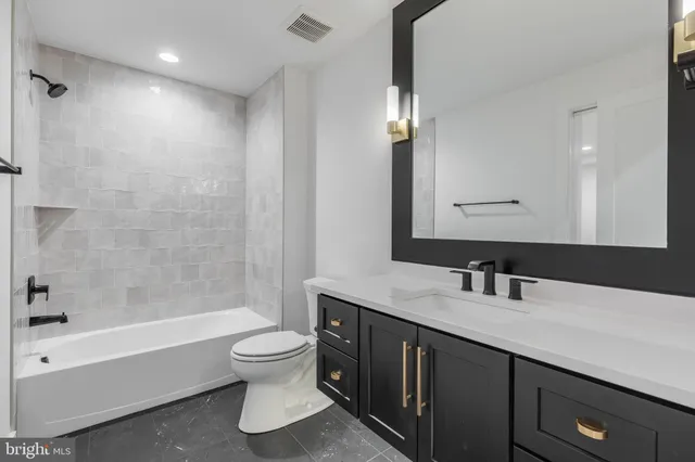 a bathroom with a sink toilet vanity and shower