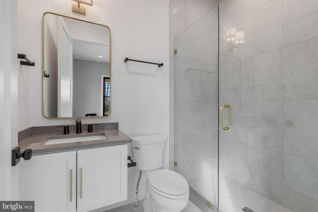 a kitchen with granite countertop a sink a stove and cabinets
