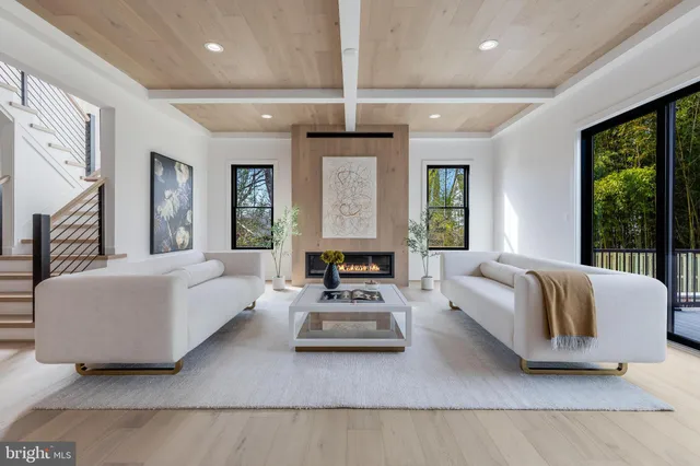 a living room with furniture and large windows