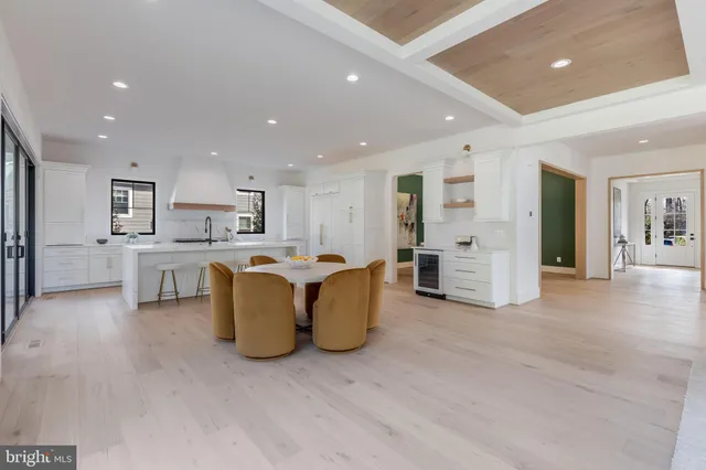 a living room with furniture and kitchen view