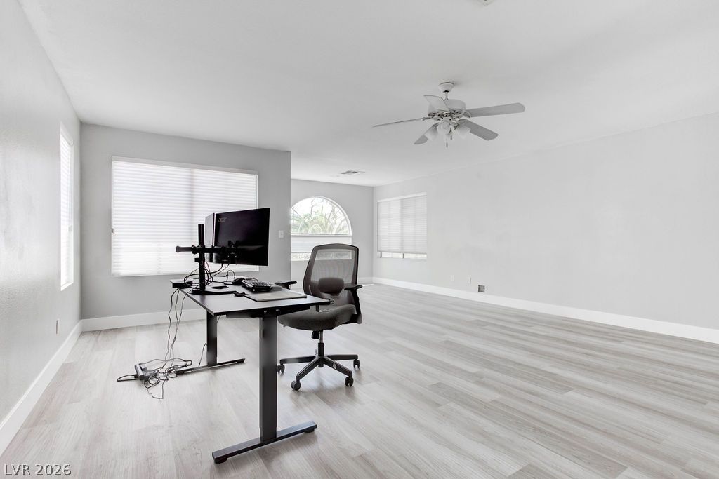 1 Rising Sun Court Henderson, NV 89074 - Photo 20 of 47 Well-lit room with wood-inspired flooring, ideal for a home office setup.