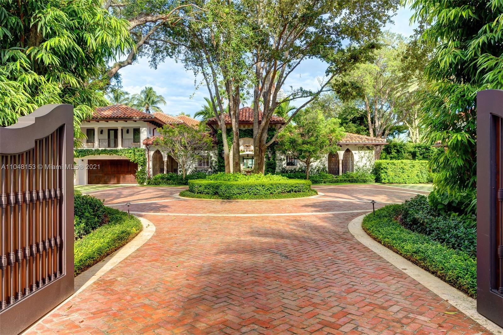 6385 Pine Tree Dr Circle Miami Beach, FL 33140 - Photo 2 of 37 a front view of a house with a yard and trees