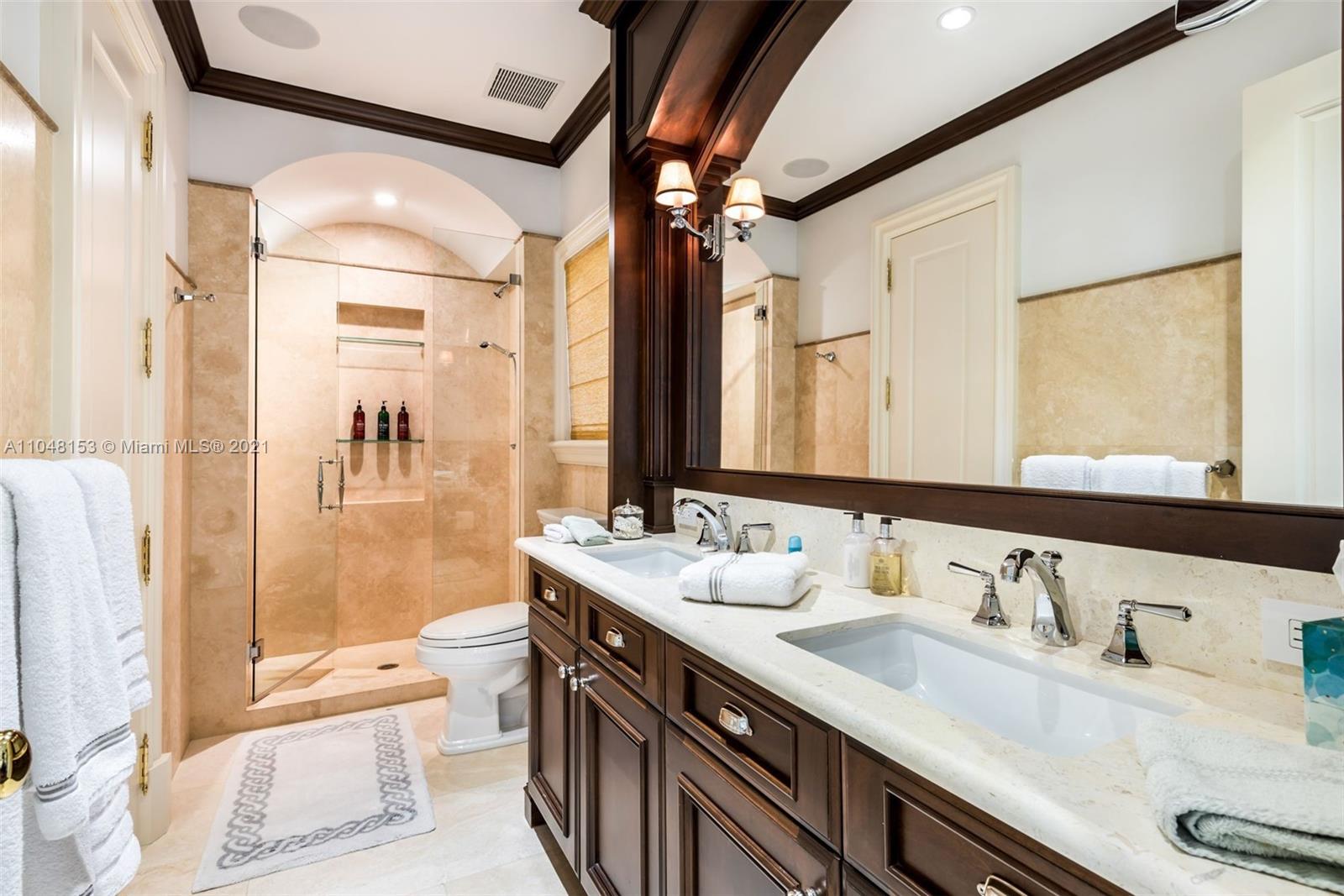 6385 Pine Tree Dr Circle Miami Beach, FL 33140 - Photo 21 of 37 a bathroom with a granite countertop sink mirror and double