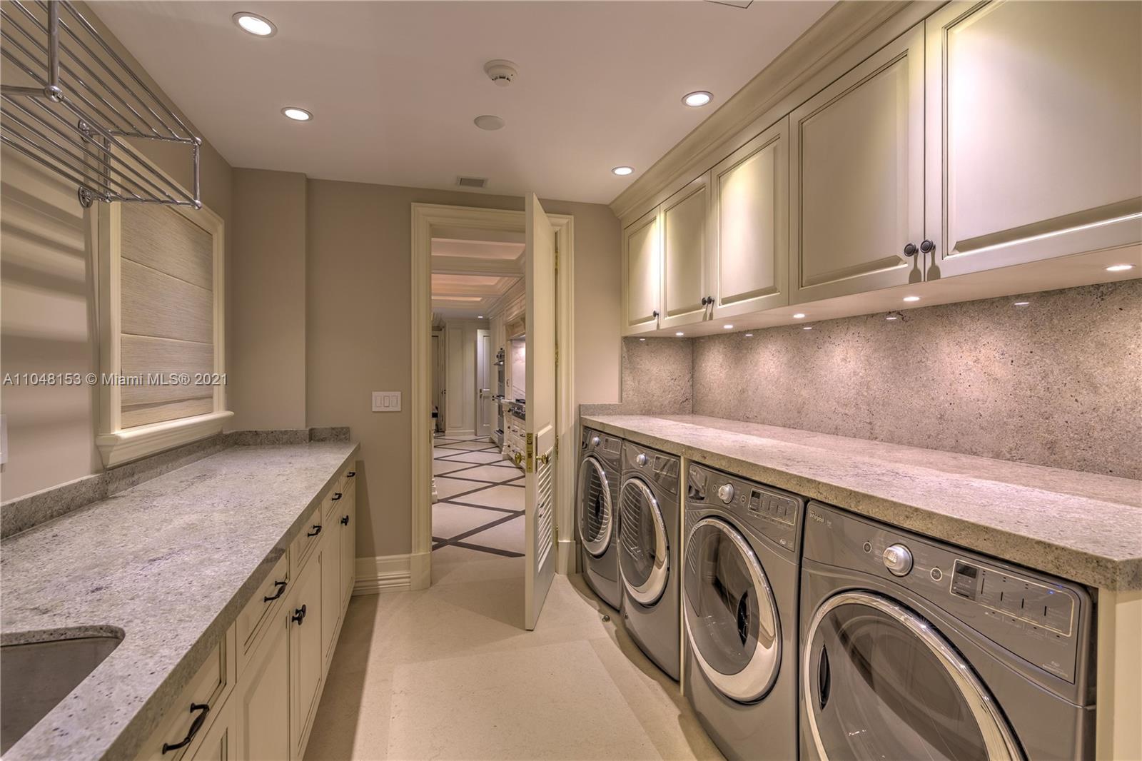 6385 Pine Tree Dr Circle Miami Beach, FL 33140 - Photo 28 of 37 a view of a kitchen with stainless steel appliances granite countertop a sink and cabinets