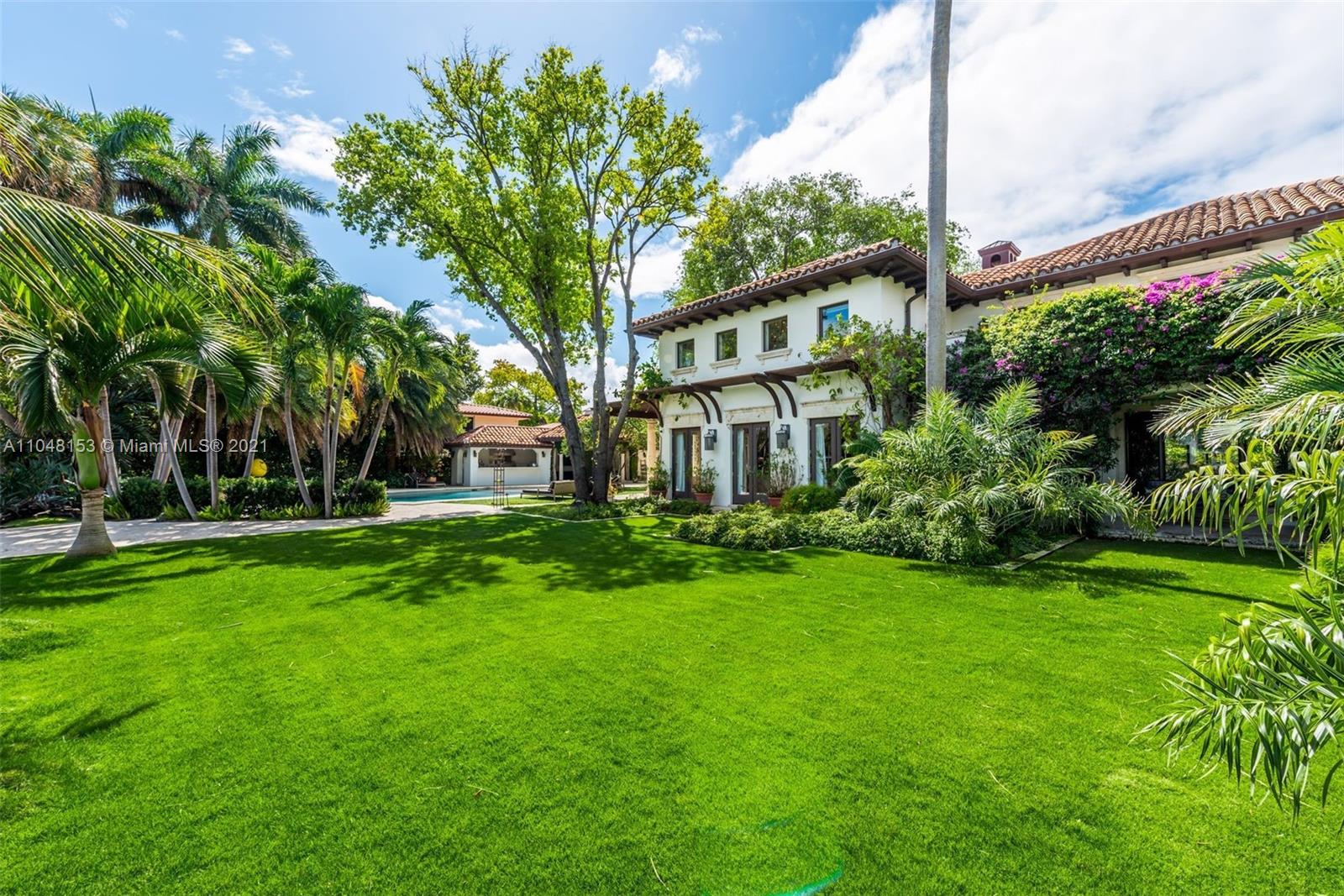 6385 Pine Tree Dr Circle Miami Beach, FL 33140 - Photo 3 of 37 a front view of a house with garden