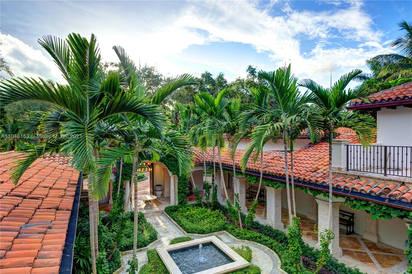 6385 Pine Tree Dr Circle Miami Beach, FL 33140 - Photo 37 of 37 a palm tree sitting in front of a house