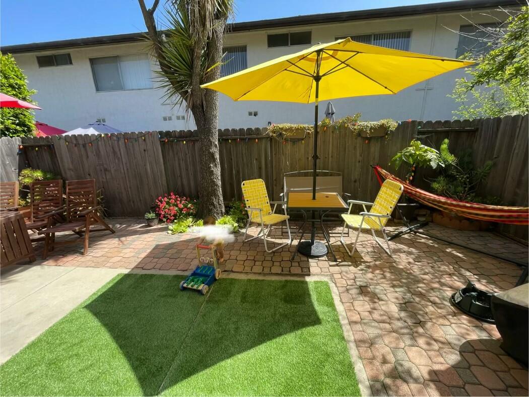 a view of backyard with a table and chairs