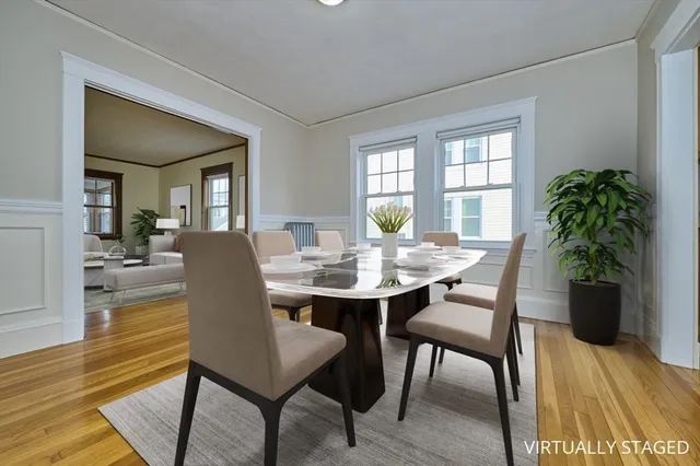 a view of a dining room with furniture window and wooden floor